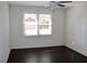 Bright bedroom featuring dark wood flooring, ample natural light, and neutral wall colors at 7645 Knollwood Dr, North Charleston, SC 29418