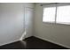Sunny bedroom with dark hardwood floors, a window, and a closet with bi-fold doors at 7645 Knollwood Dr, North Charleston, SC 29418