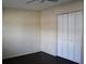 Bedroom with dark hardwood floors, white walls, and a closet with bi-fold doors at 7645 Knollwood Dr, North Charleston, SC 29418