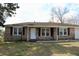 Well-kept brick home with a tidy lawn, offering classic curb appeal at 7645 Knollwood Dr, North Charleston, SC 29418