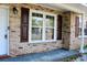 Close-up view of the front porch with brick details and white trim at 7645 Knollwood Dr, North Charleston, SC 29418