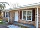 Inviting front porch with brick accents, offering a cozy entrance to the home at 7645 Knollwood Dr, North Charleston, SC 29418