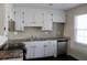 Contemporary kitchen with white cabinets, stainless steel appliances, and stylish backsplash at 7645 Knollwood Dr, North Charleston, SC 29418