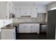 Charming kitchen with white cabinets, stainless steel appliances, and beautiful tile backsplash at 7645 Knollwood Dr, North Charleston, SC 29418