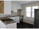 Cozy kitchen with white cabinets, stainless steel appliances and a large window at 7645 Knollwood Dr, North Charleston, SC 29418