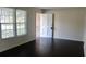 Bright living room featuring dark wood flooring, large windows and ample natural light at 7645 Knollwood Dr, North Charleston, SC 29418