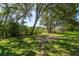 Expansive backyard with stepping stones leading to a patio, perfect for entertaining or relaxing in nature at 8869 Marsh Aire Ln, Edisto Island, SC 29438