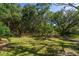Serene backyard surrounded by mature trees, offering privacy and a tranquil escape into nature's beauty at 8869 Marsh Aire Ln, Edisto Island, SC 29438