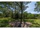 The spacious backyard boasts a brick patio, lush lawn, and mature trees at 8869 Marsh Aire Ln, Edisto Island, SC 29438