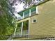 Coastal home featuring double balconies on the main entrance and upper level, enhancing outdoor living at 8869 Marsh Aire Ln, Edisto Island, SC 29438