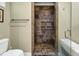 Walk in shower with tile walls and pebble flooring at 8869 Marsh Aire Ln, Edisto Island, SC 29438