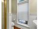 Window in bathroom with white blind and view to exterior at 8869 Marsh Aire Ln, Edisto Island, SC 29438