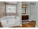 Neutral Primary bathroom featuring a large soaking tub and tile surround at 8869 Marsh Aire Ln, Edisto Island, SC 29438