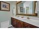 Bathroom with a double vanity, framed mirror, decorative fixtures, and clean white countertops at 8869 Marsh Aire Ln, Edisto Island, SC 29438