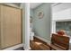 Bright bathroom with a glass-enclosed shower, a rustic bench, and a window offering outdoor views at 8869 Marsh Aire Ln, Edisto Island, SC 29438