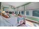 Bright bedroom showcasing two beds, many windows, and light green walls at 8869 Marsh Aire Ln, Edisto Island, SC 29438