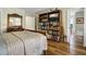 Comfortable bedroom featuring a bookcase with a TV and a view into the next room at 8869 Marsh Aire Ln, Edisto Island, SC 29438