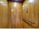 Interior view of elevator with wood panels, hand rail, and floor selection buttons at 8869 Marsh Aire Ln, Edisto Island, SC 29438
