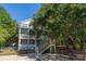 Beautiful home with a pool and lush surroundings, creating a serene and private outdoor space for relaxation at 8869 Marsh Aire Ln, Edisto Island, SC 29438