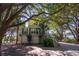Charming two-story home with a lush canopy of mature trees for plenty of shade and curb appeal at 8869 Marsh Aire Ln, Edisto Island, SC 29438