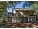 Rear exterior showcasing elevated design with a screened porch, supported by lattice and ample parking underneath at 8869 Marsh Aire Ln, Edisto Island, SC 29438