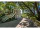 Multi-story home with a long driveway and lush trees surrounding the property for added privacy at 8869 Marsh Aire Ln, Edisto Island, SC 29438