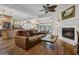Inviting living room with fireplace and beautiful hardwood floors offering a view to the kitchen at 8869 Marsh Aire Ln, Edisto Island, SC 29438