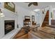 Inviting living room with a fireplace, TV, fan, and a comfortable leather sofa at 8869 Marsh Aire Ln, Edisto Island, SC 29438