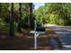 Mailbox with visible address numbers on a quiet, tree-lined street near the house at 8869 Marsh Aire Ln, Edisto Island, SC 29438