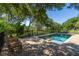 Inviting pool with spa and paver patio, surrounded by mature trees, creating a private and tranquil retreat at 8869 Marsh Aire Ln, Edisto Island, SC 29438