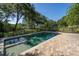 Sparkling pool and paver patio surrounded by lush landscaping, offering a private and serene outdoor oasis at 8869 Marsh Aire Ln, Edisto Island, SC 29438