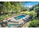 Aerial view of the backyard oasis featuring a sparkling pool and spa, perfect for relaxation and outdoor entertainment at 8869 Marsh Aire Ln, Edisto Island, SC 29438