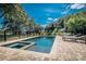 Backyard pool and spa complemented with brick pavers and lounge chairs, perfect for outdoor relaxation and entertainment at 8869 Marsh Aire Ln, Edisto Island, SC 29438