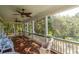 Relaxing screened porch with ceiling fans and a view of the lush, green backyard at 8869 Marsh Aire Ln, Edisto Island, SC 29438