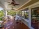 Inviting porch with wicker furniture, ceiling fans, and scenic views at 8869 Marsh Aire Ln, Edisto Island, SC 29438