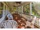 Comfortable seating on a screened porch with wooded views at 8869 Marsh Aire Ln, Edisto Island, SC 29438