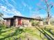 Back exterior elevation with brick walls, a shed, green grass, and blue skies with light, puffy clouds at 9 Grover Ln, Goose Creek, SC 29445