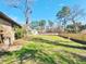 Backyard featuring a green lawn, a new, wood fence, brick walls, and mature shade trees at 9 Grover Ln, Goose Creek, SC 29445