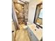 Bathroom with marble tiled shower and white single sink vanity at 9 Grover Ln, Goose Creek, SC 29445
