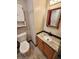 Bathroom featuring a wood vanity, granite countertops, white sink, medicine cabinet, and marble-look floors at 9 Grover Ln, Goose Creek, SC 29445