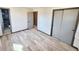 Spacious bedroom with wood-look flooring and sliding door closet, bathroom access visible at 9 Grover Ln, Goose Creek, SC 29445