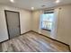 Bedroom with a window and dark-trimmed door and wood-look flooring at 9 Grover Ln, Goose Creek, SC 29445