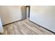 Neutral bedroom with wood-look floors, open door, and closet at 9 Grover Ln, Goose Creek, SC 29445