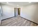 Neutral bedroom featuring wood-look floors and large window with curtains at 9 Grover Ln, Goose Creek, SC 29445