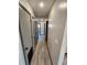 Long hallway with several doors and wood-look flooring at 9 Grover Ln, Goose Creek, SC 29445