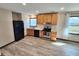 Contemporary kitchen with wood cabinets, stone countertops, stainless steel appliances, and wood-look vinyl flooring at 9 Grover Ln, Goose Creek, SC 29445