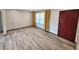 Spacious living room with wood flooring, neutral walls, a large window, and a red front door at 9 Grover Ln, Goose Creek, SC 29445