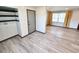 Open-concept living room with wood flooring, neutral walls, large windows, built-in shelving, and utility hookups at 9 Grover Ln, Goose Creek, SC 29445