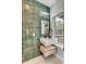 Modern bathroom featuring sleek floating vanity, stylish green tile, and window at 915 Dill Ave, Charleston, SC 29412