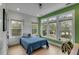 Bright bedroom with large windows, hardwood floors, and modern green walls at 915 Dill Ave, Charleston, SC 29412